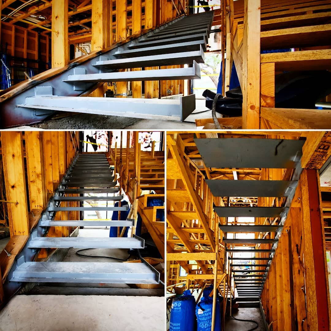 Three views of cantilevered steel stair stringers installed in an open timber-framed structure