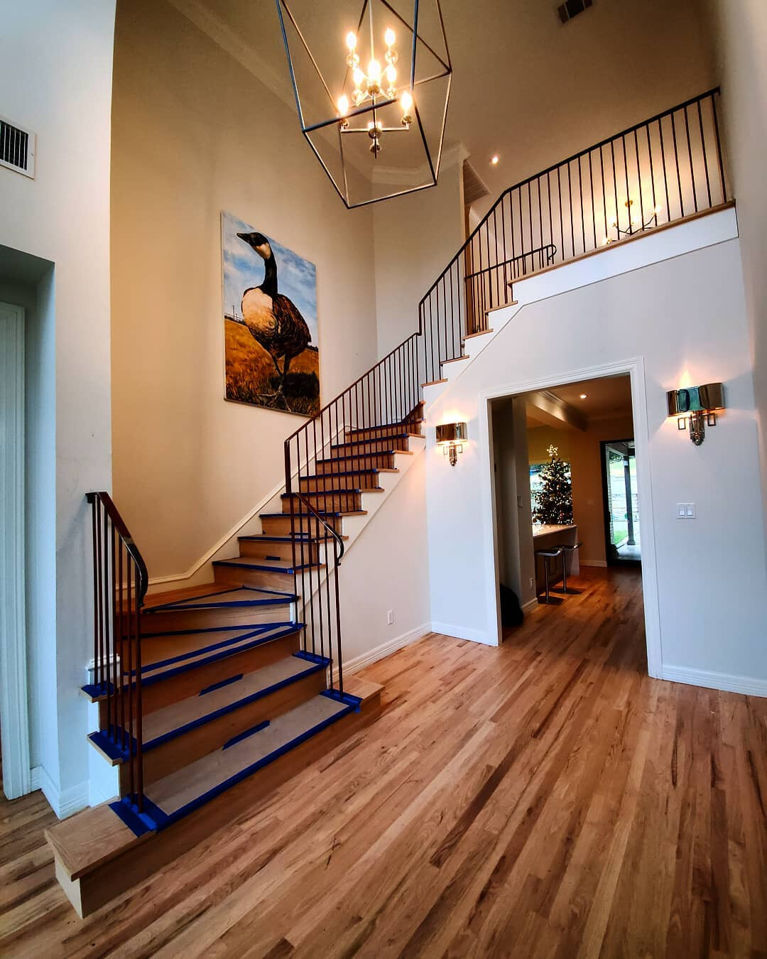 Finished steel handrail and balustrade on a wooden staircase in a two-story entryway